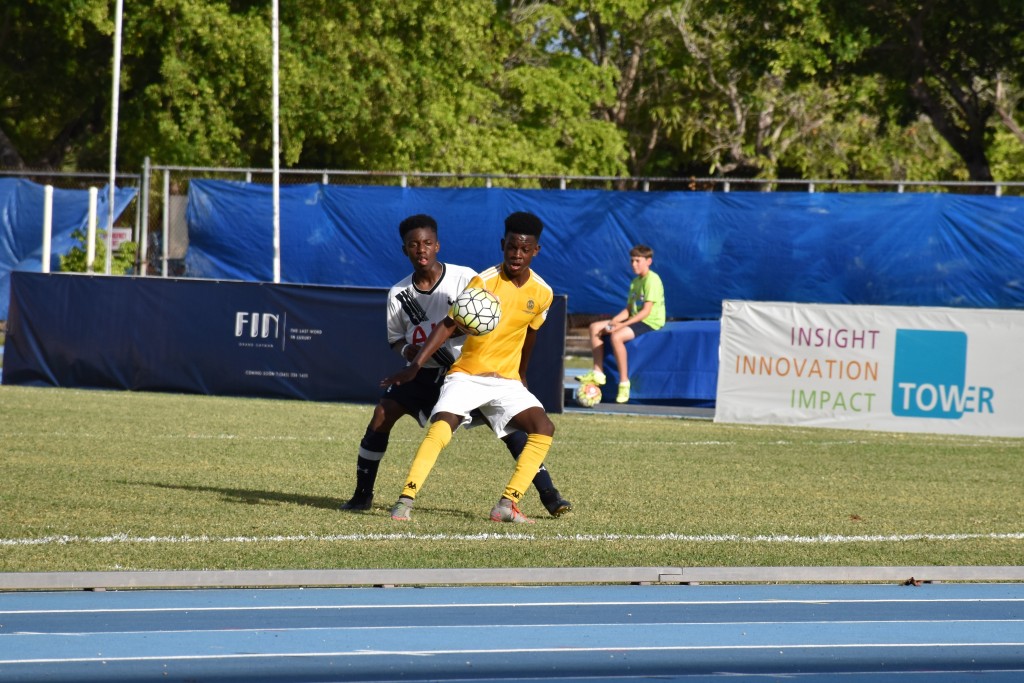 Harbour View's Kafui Doouet (yellow) tries to maintain possession away from Tottenham's Rio Campbell.