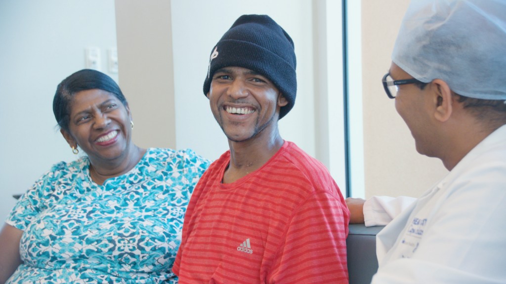 Bjorn Ebanks (center) with his mother Ingrid Ebanks speaking with Dr. Binoy Chattuparambil at Health City Cayman Islands following his recovery. 